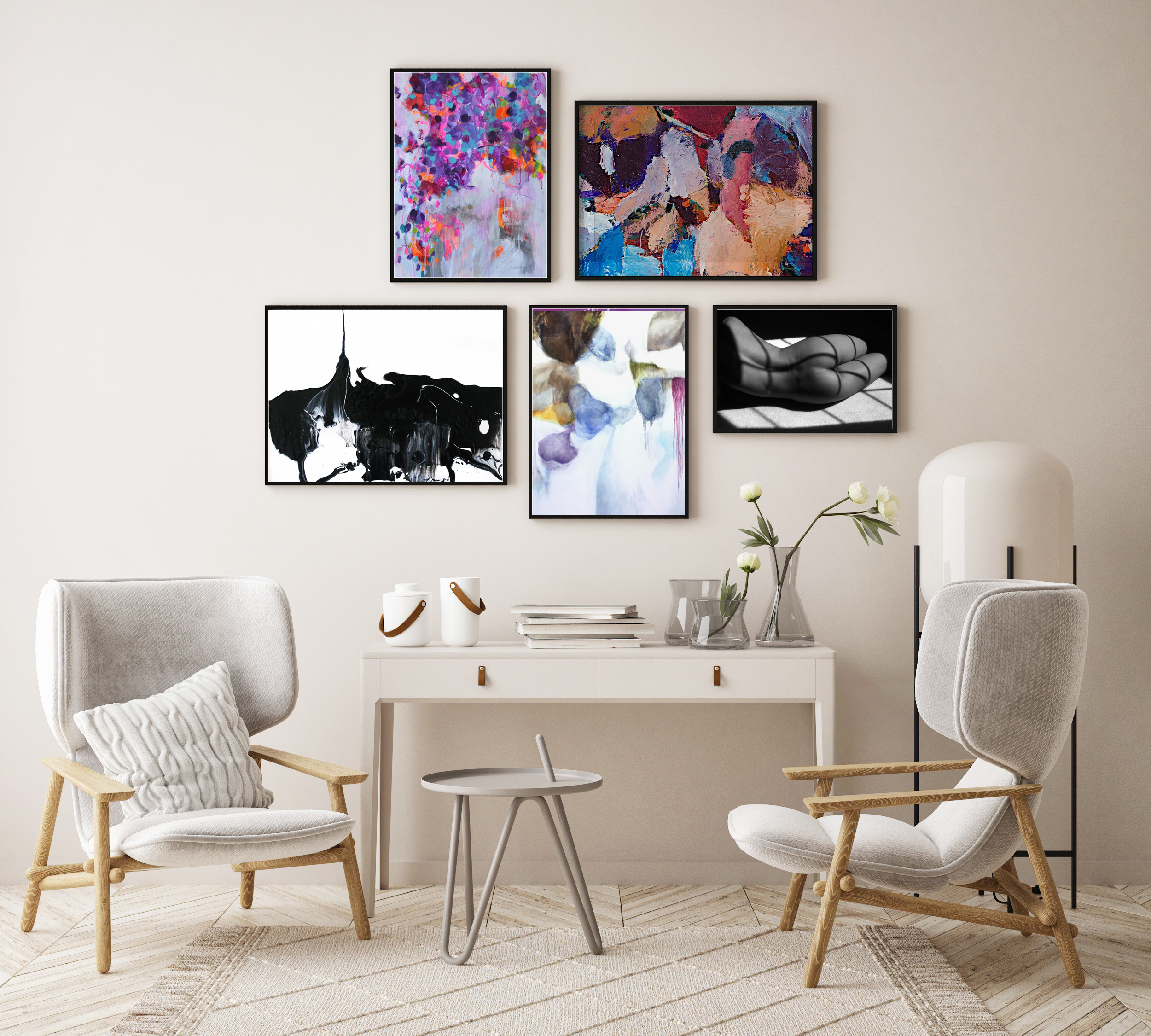 gallery wall above table and chairs with mix of artwork abstracts and photographs